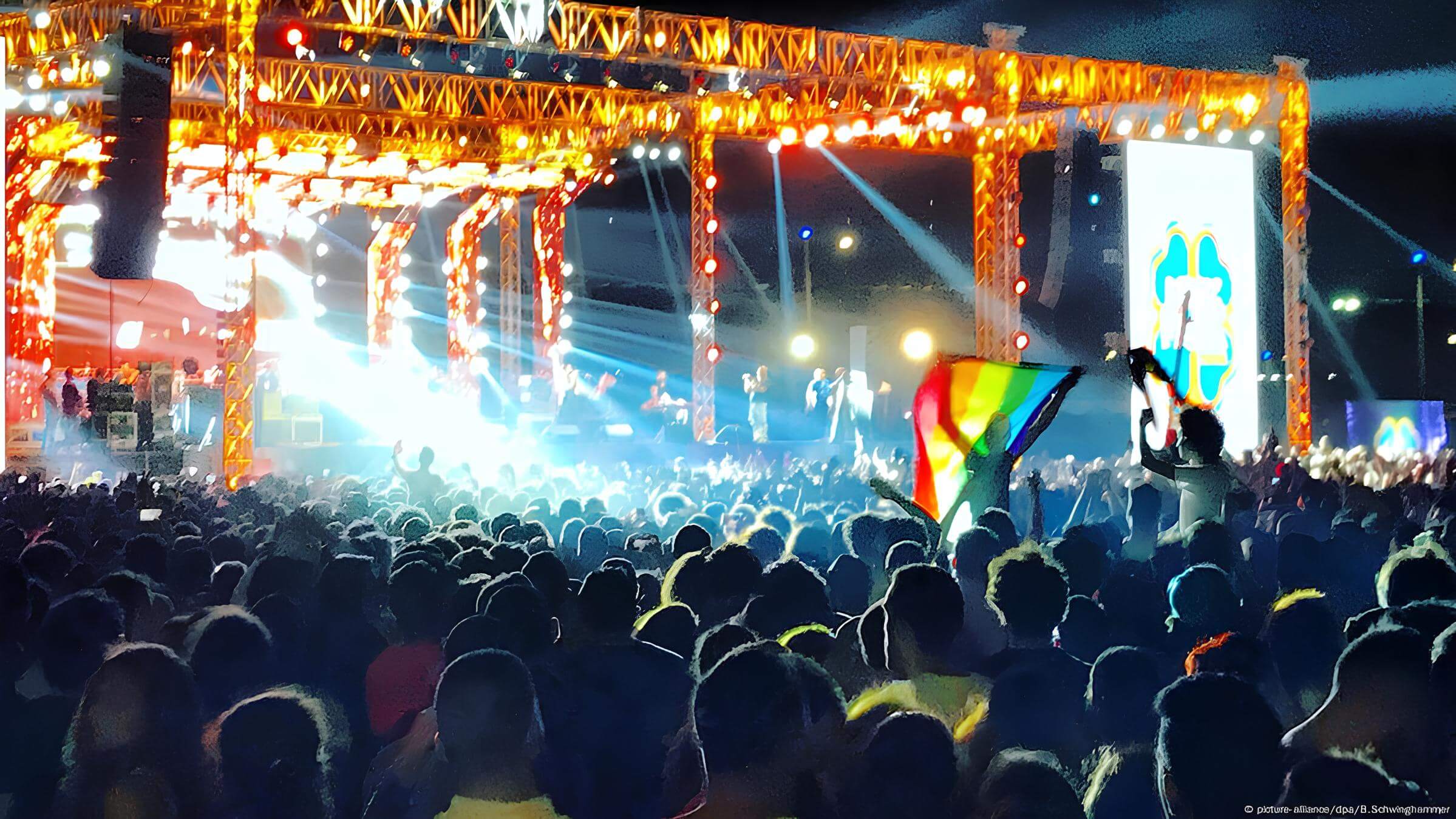 Sarah Hegazy holding the LGBTQ+ flag in Mashrou' Leila's concert